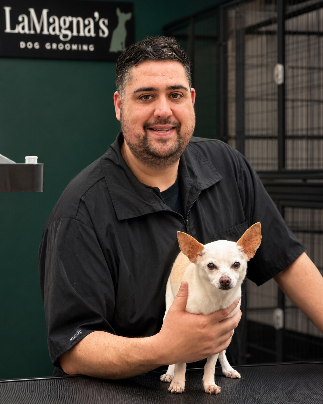 Groomer Joey holding Jack Daniels at LaMagna's Dog Grooming in Floral Park, NY